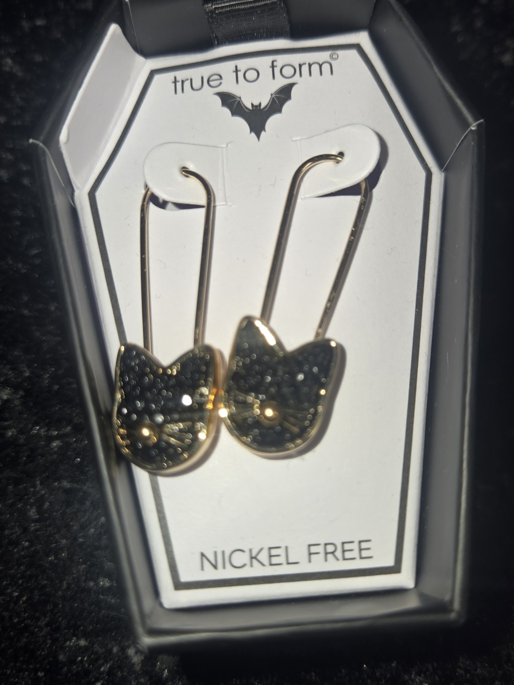 True to Form Gold Cat Head Drop Earrings with Black Glitter